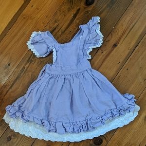 A toddler girl jumper dress.